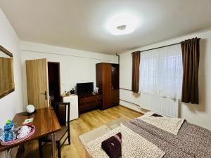 a living room with a table and a dining room at Penzión Tyché in Šurany