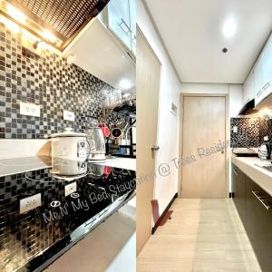a kitchen with black and white tiles on the wall at Me N’ My Bed Staycation @ SMDC Trees Residences in Manila