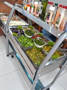 a food cart filled with lots of different vegetables at Hotel Cesar Nogueira in Aparecida