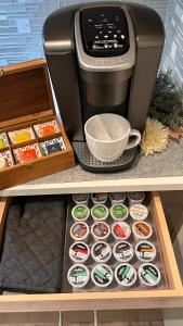 a coffee maker and a box of cupcakes in a drawer at Posh 210 in San Antonio