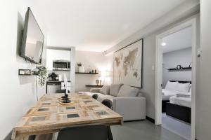 a living room with a table and a bedroom at Parc Avenue Lofts in Montreal