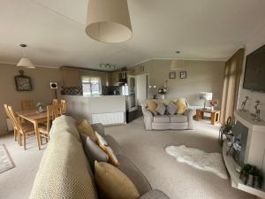 a living room with a couch and a table at Ness Lodge in Little Habton