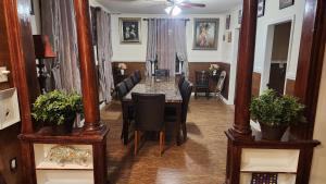 a dining room with a long table and chairs at 4 Bedroom Few Blocks From Beach , Tropicana Casino , Stockton University , Bay in Atlantic City