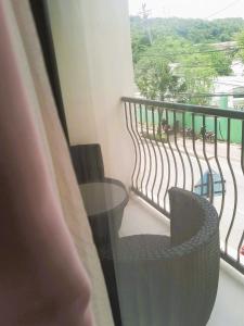 a balcony with a glass table and a chair at YCL HOTEL BORACAY in Boracay
