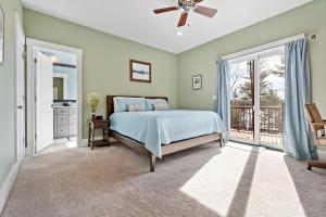 a bedroom with a bed and a balcony at The Waterman Lakefront Luxury with Hot Tub & Private Dock! in Jacktown