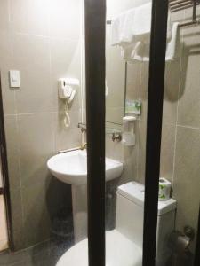 a small bathroom with a sink and a toilet at YCL HOTEL BORACAY in Boracay