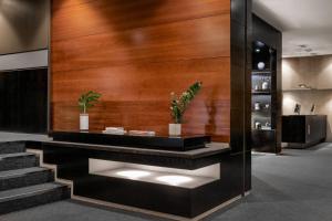 a lobby with a wooden wall and stairs at AC Hotel Los Vascos by Marriott in Madrid