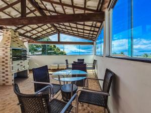a dining room with chairs and a table and a table and chairsktop at Village Encantado in Guarajuba