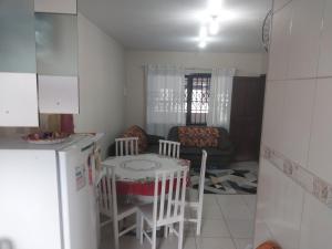 a kitchen and living room with a table and chairs at Casa da ana in Penha +3 photos