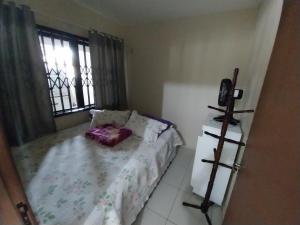 a small bedroom with a bed and a window at Casa da ana in Penha