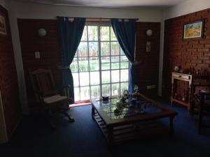 a living room with a glass table and a large window at Quinta Don Diego in Piñero