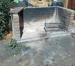 a bench sitting on top of a brick wall at Departamentos Lina in El Bolsón