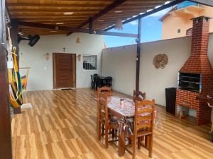 a dining room with a table and chairs at Casa alter oficial in Alter do Chao