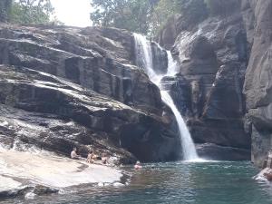 a group of people in the water at a waterfall at Princess of Dickoya Homestay in Hatton