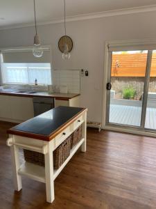 a kitchen with a island in the middle of a room at Central Yarrawonga in Yarrawonga
