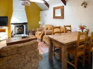 un soggiorno con tavolo e divano di Cross Cottage a Saint Breward