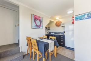 a kitchen and dining room with a table and chairs at Central CBD in Motueka