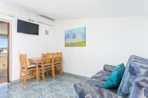 a living room with a couch and a table at Apartments by the sea Sevid, Trogir - 4287 in Sevid