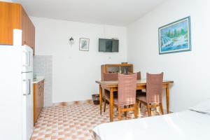 a kitchen with a dining room table and chairs at Apartment Sevid 4287d in Sevid