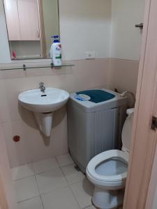 a small bathroom with a toilet and a sink at October Homes, Field Residences, Sucat, Parañaque, Airport Express in Manila