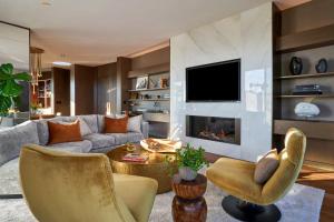 a living room with a couch and a fireplace at The Dupont Circle Hotel in Washington