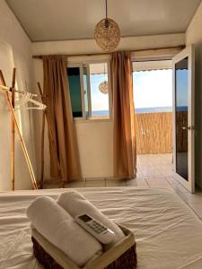 a bedroom with a bed with a remote control on it at Surf House Mizata in Santa María Mizata
