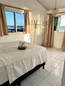 een slaapkamer met een bed en uitzicht op de oceaan bij Surf House Mizata in Santa María Mizata