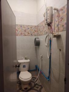 a bathroom with a toilet and a shower at Erawan Guesthouse in Pakse