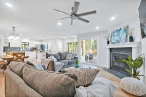 a living room with a couch and a fireplace at Middle Sound Hideaway~Beaches, Shopping, Families in Wilmington