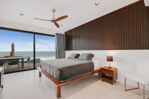 a bedroom with a bed and a view of the ocean at Villa E11even con C hef Privado Ocean Front in Isla Mujeres