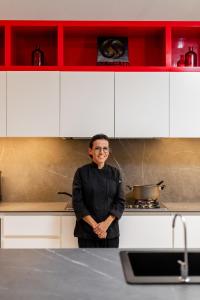 a woman is standing in a kitchen at Villa E11even con C hef Privado Ocean Front in Isla Mujeres