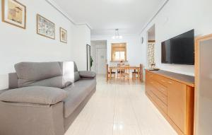 a living room with a couch and a tv at 2 Bedroom Nice Apartment In Oropesa Del Mar in Oropesa del Mar