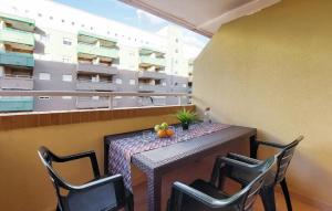 a table with chairs and fruit on a balcony at 2 Bedroom Nice Apartment In Oropesa Del Mar in Oropesa del Mar