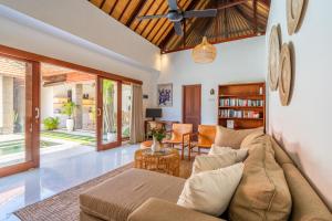 a living room with a couch and a table at VILLA JIWA SANUR in Sanur