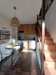 a kitchen and a dining room with a table and stairs at Casetta vista lago con giardino Gandria in Gandria