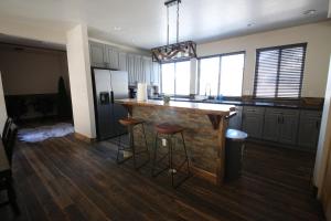 a kitchen with a counter and stools in it at Mount Jumbo Lookout in Missoula