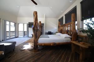 a bedroom with a bed made out of logs at Mount Jumbo Lookout in Missoula