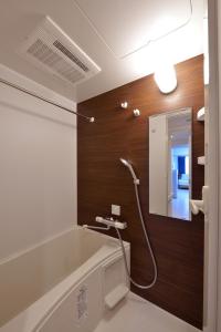 a bathroom with a shower with a mirror at Hostel Inn Tokyo Asakusa East in Tokyo