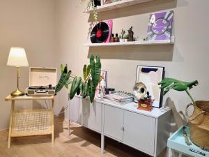 a room with a white cabinet with plants and a lamp at Vilana Hotel in Arau