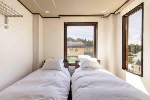 Un pat sau paturi într-o cameră la Address Nagasaka