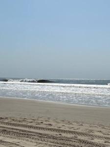 a beach with the ocean in the background at Beach residence vila with pool in Kabrousse