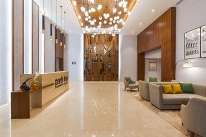 a lobby of a hotel with a couch and chairs at Park Inn by Radisson Ayodhya in Ayodhya