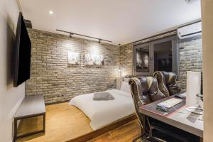 a bedroom with a bed and a brick wall at Incheon Stay Inn Hotel in Incheon