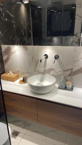 a bathroom with a white sink and a mirror at Sea-side Mountain Villa in Iraklitsa +44 photos