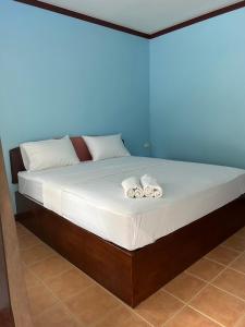 a bed in a room with two towels on it at Adam Bungalows in Krabi town