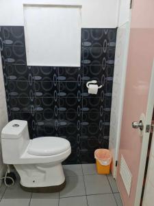 a small bathroom with a toilet and a shower at AABANA Beach & Watersport Resort in Malapascua Island