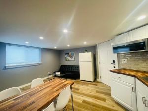 a kitchen with a table and a white refrigerator at Green Lake 1st Line Home D Full Modern Remodeled in Seattle