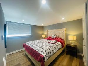 a bedroom with a bed with a red and white comforter at Green Lake 1st Line Home D Full Modern Remodeled in Seattle