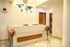 a reception room with a world map on the wall at Hotel Aaram Kalupur in Ahmedabad