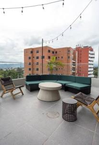 a balcony with a table and chairs on a building at Tropical Apartment in the city in Guatemala